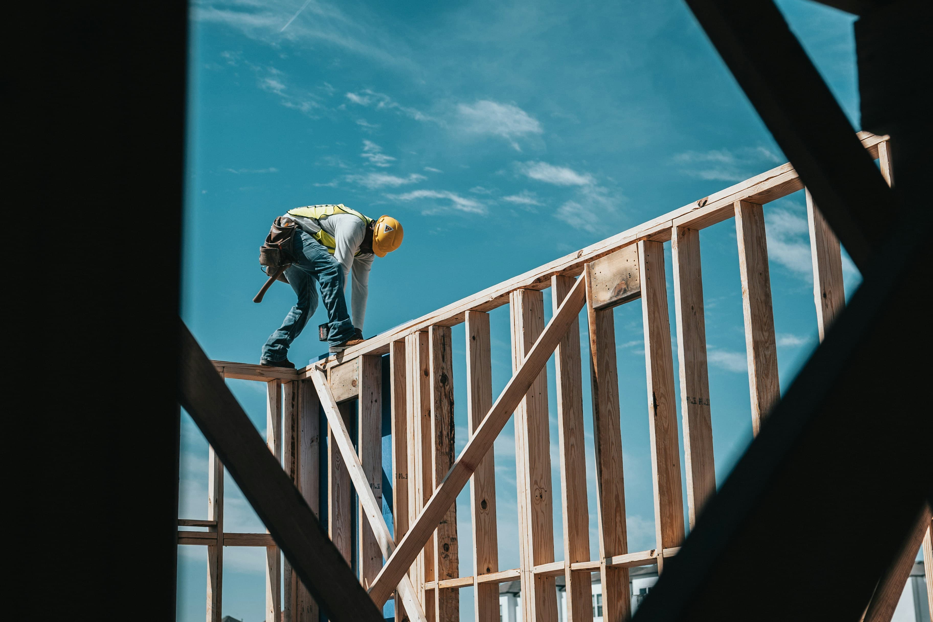 Construction worker in a hard hat working on a building frame