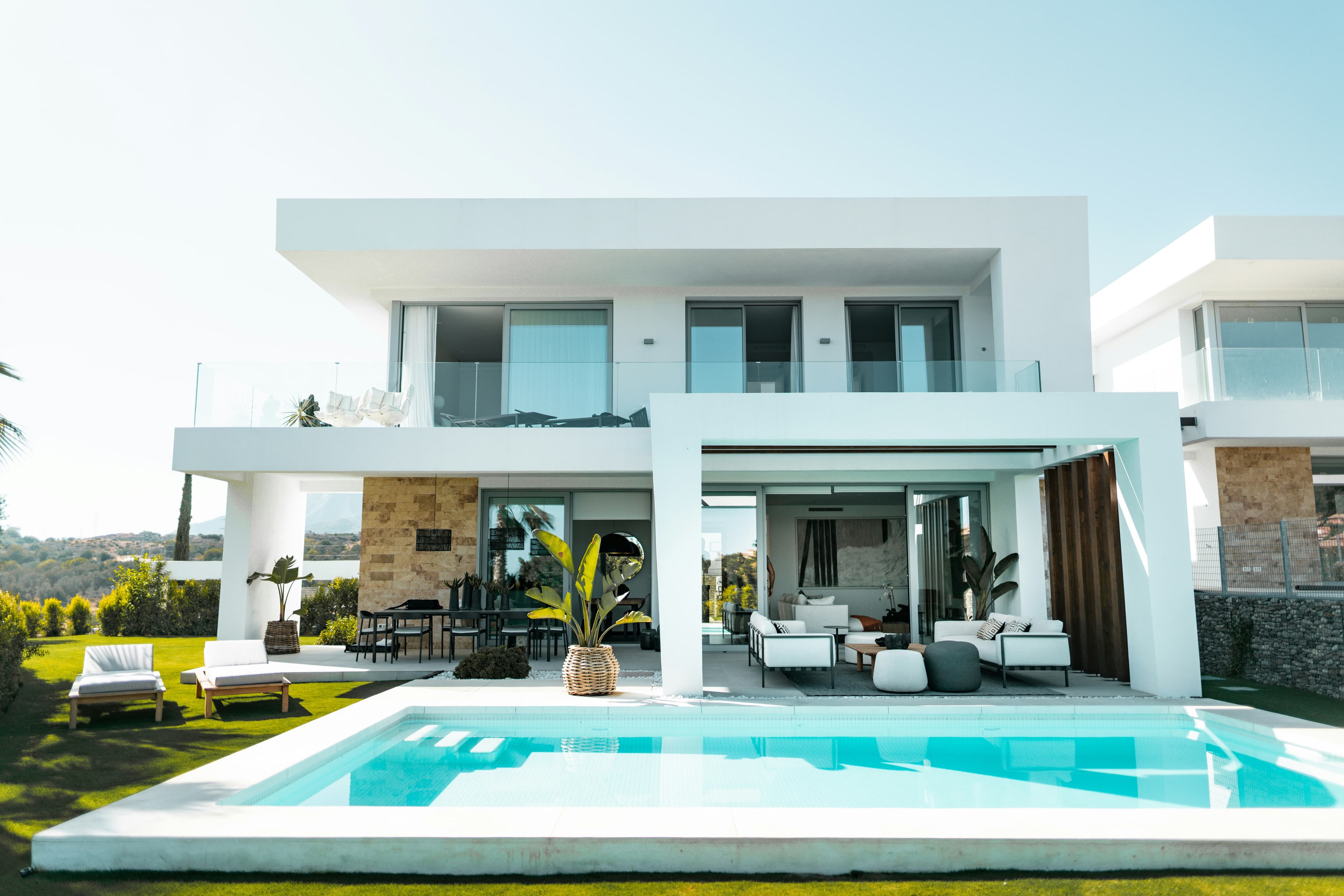 Modern white villa with a swimming pool and outdoor lounge area